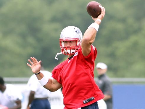 Tim Tebow throws a pass in his first practice with the New England Patriots.