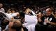 Game 3 in San Antonio: Spurs 113, Heat 77 - Spurs forward Tim Duncan rests on fans after diving for a loose ball.