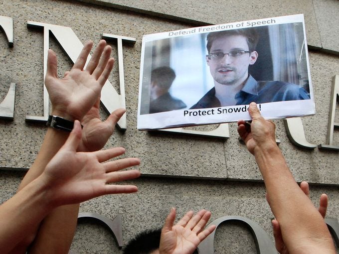 A demonstrator holds a picture of Edward Snowden, a former contractor who leaked top-secret information about U.S. surveillance programs, during a protest outside the U.S. Consulate on June 13 in Hong Kong.