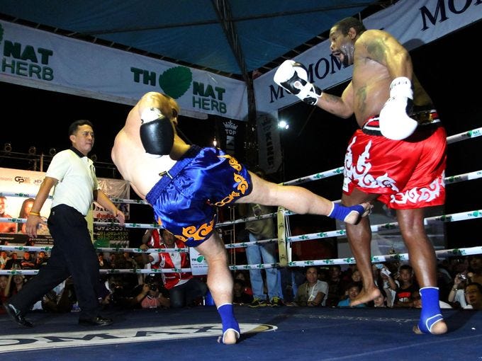 Riddick Bowe gets kicked on the leg by Levgen Golovin during their  World Muay Thai fight.