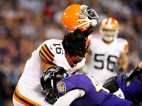Browns wide receiver Josh Cribbs gets his helmet knocked off by Ravens long snapper Morgan Cox at M,T Bank Stadium in 2012.