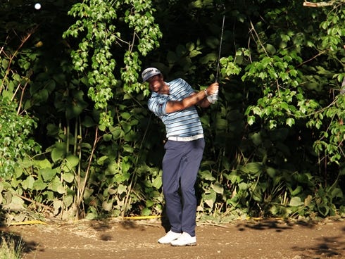 In trouble again, Keegan Bradley plays from in the trees on the 12th hole.
