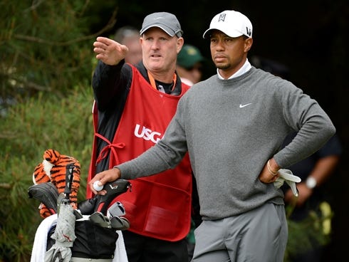 Tiger Woods and caddie Joe LaCava talk about the 11th hole during the second round of the 113th U.S. Open golf tournament at Merion Golf Club outside Philadelphia.
