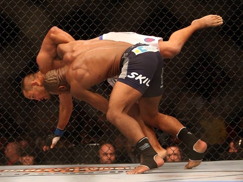 Rashad Evans (right) grapples with Dan Henderson during their light heavyweight bout at UFC 161 at MTS Centre.