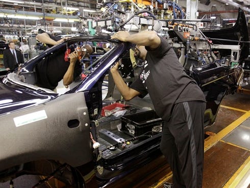 In this 2011 photo, an assemblyman works on the line building Chrysler 200 vehicles at the Sterling Heights Assembly Plant in Sterling Heights, Mich.