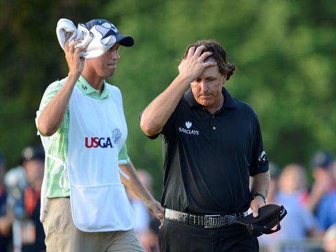 Phil Mickelson (right) and caddie Jim Mackay (left) react after coming up two shots shy of winning the 113th U.S. Open on Sunday at Merion Golf Club outside Philadelphia.