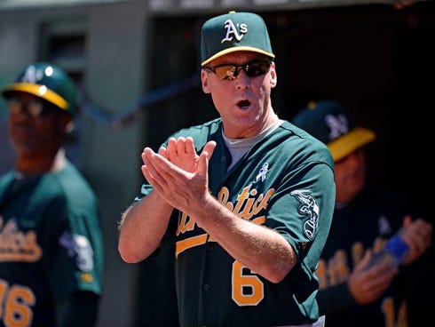 Oakland Athletics manager Bob Melvin motivates his bench in the fifth inning against the  Seattle Mariners at O.co Coliseum.