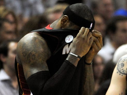Heat forward LeBron James wipes his face with his jersey during a frustrating moment of Game 5 of the NBA Finals on Sunday.