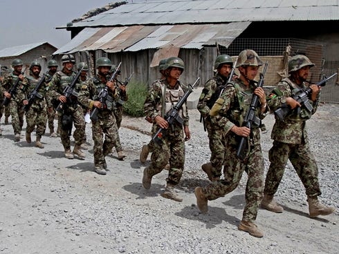 Afghan National Army soldiers march in Sangin district of Kandahar province southern Afghanistan.