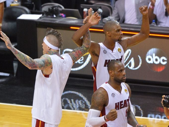 Game 6 in Miami: Heat 103, Spurs 100 (OT) - Miami Heat center Chris Bosh, middle, and Chris Andersen, left, LeBron James celebrate after overtime their victory.