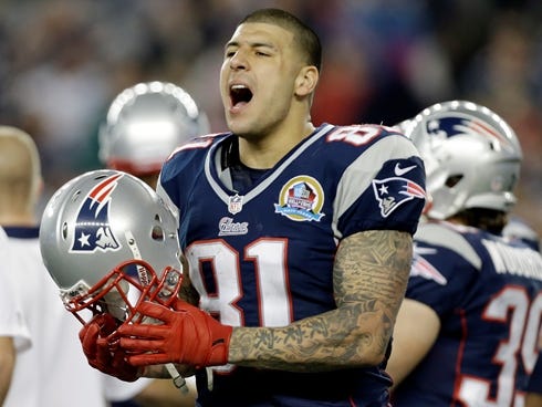 In this Dec. 10, 2012 file photo, New England Patriots tight end Aaron Hernandez reacts during the second quarter of an NFL football game against the Houston Texans in Foxborough, Mass.  State and local police spent hours at the home of New England P