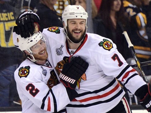 Chicago Blackhawks defenseman Brent Seabrook (7) celebrates with defenseman Duncan Keith (2) after scoring in overtime against the Boston Bruins.