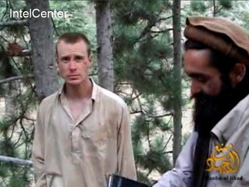 A frame grab from a video released by the Taliban shows a man believed to be Bowe Bergdahl, left.