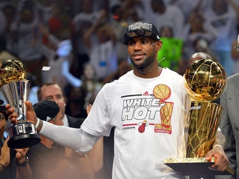 Miami Heat small forward LeBron James holds the MVP trophy and the Larry O'Brien Championship trophy after defeating the San Antonio Spurs in game seven in the 2013 NBA Finals at American Airlines Arena. Miami Heat won 95-88 to win the NBA Championsh