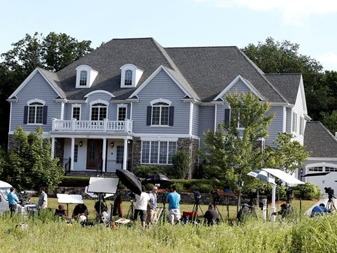Members of the media stake out the house of New England Patriots tight end Aaron Hernandez in North Attleborough, Mass.