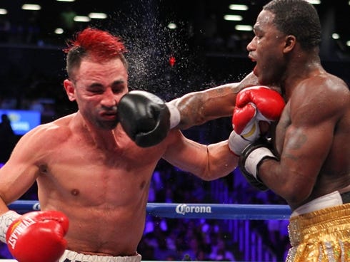 Adrien Broner, right, and Paulie Malignaggi  trade punches during their 12 round WBA welterweight championship bout Saturday. Broner won by split decision.