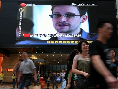 A TV screen shows a news report of Edward Snowden, a former CIA employee who leaked top-secret documents about sweeping U.S. surveillance programs, at a shopping mall in Hong Kong on Sunday.