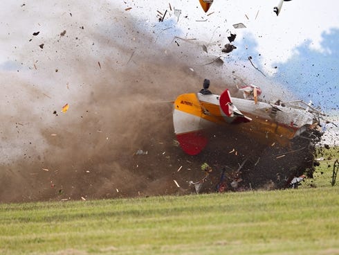 A stunt plane with a wing walker crashes during a performance at the Vectren Air Show, June 22, in Dayton, Ohio.