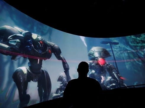 Alex Beckers watches a presentation of the video game 'Destiny' at the Activision-Blizzard booth during the Electronic Entertainment Expo in Los Angeles