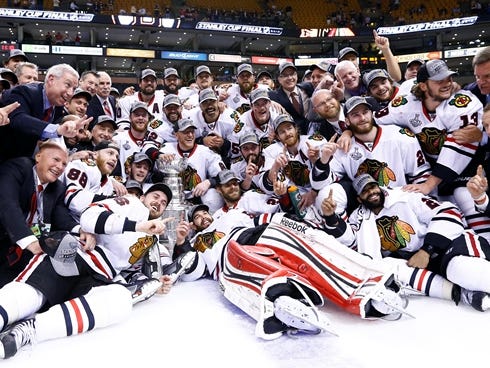 The Blackhawks pose with the Stanley Cup.