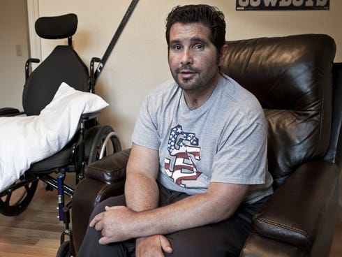 Bryan Stow, 44, sits Tuesday in his bedroom at his parents��� house in Capitola, Calif. ���If you ask Bryan what his career is, he is still a paramedic in his head,��� says his mother, Ann. ���But he will not be a paramedic again. Bryan has holes in his memo