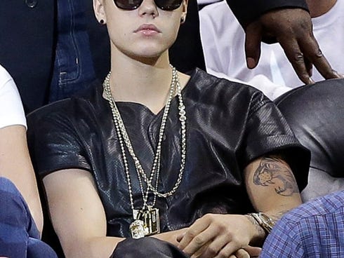 Singer Justin Bieber watches players during the first half of Game 7 in their NBA basketball Eastern Conference finals playoff series between the Miami Heat and the Indiana Pacers, Monday, June 3, 2013 in Miami. (AP Photo/Lynne Sladky)