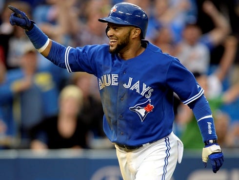 Toronto Blue Jays' Emilio Bonifacio jumps in the air while running home to the game-winning run off a hit by teammate Rajai Davis in the 18th inning against the Texas Rangers in Toronto.