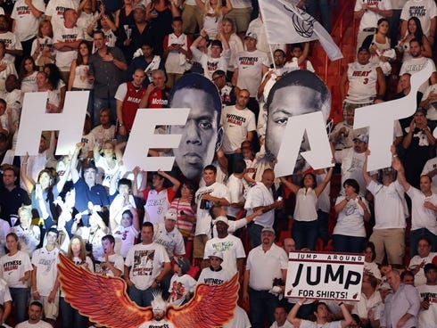 Jun 6, 2013; Miami, FL, USA; Miami Heat fans cheer with a large Heat sign against the San Antonio Spurs in the fourth quarter during game one of the 2013 NBA Finals at the American Airlines Arena. Mandatory Credit: Derick E. Hingle-USA TODAY Sports