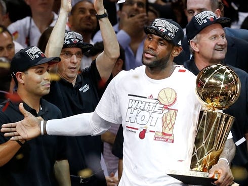 Jun 20, 2013; Miami, FL, USA; Miami Heat guard LeBron James celebrates with the Larry O' Brien Championship trophy after game seven in the 2013 NBA Finals at American Airlines Arena. Miami defeated the San Antonio Spurs 95-88 to win the NBA Champions
