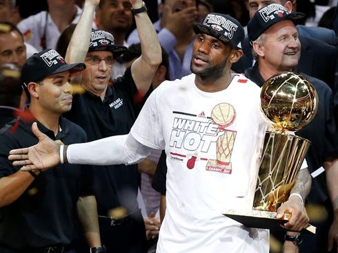 Miami Heat guard LeBron James celebrates with the Larry O' Brien Championship trophy after game seven in the 2013 NBA Finals at American Airlines Arena. Miami defeated the San Antonio Spurs 95-88 to win the NBA Championship.
