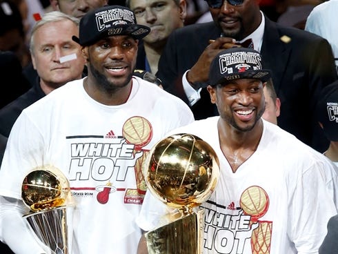 Miami Heat small forward LeBron James (left) and Dwyane Wade (right) celebrate after game seven in the 2013 NBA Finals at American Airlines Arena.