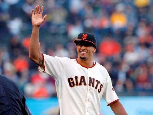 Jun 21, 2013; San Francisco, CA, USA; San Francisco 49ers quarterback Colin Kaepernick acknowledges the crowd prior to throwing out the first pitch before the start of the game between the San Francisco Giants and the Miami Marlins at AT,T Park. Mand