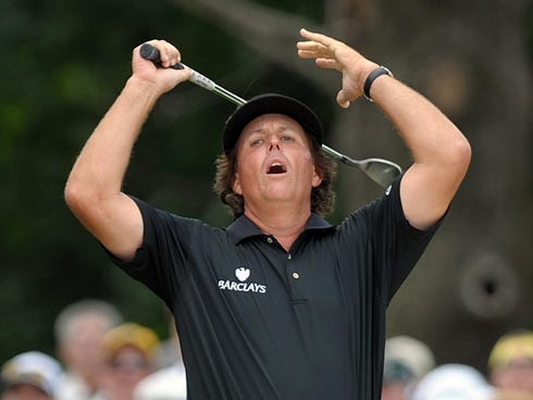 Phil Mickelson reacts as his ball hit from a bunker narrowly misses the hole on an eagle-attempt during the final day of the U.S. Open golf tournament on Sunday, June 16, 2013, at Merion Golf Club in Ardmore, Pa. (AP Photo/The Express-Times, Matt Smi