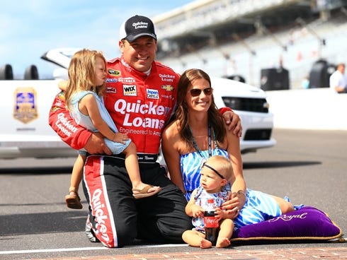 Ryan Newman poses for a photo at the bricks of Indianapolis Motor Speedway with his wife Krissie Newman and their daughters after winning the Samuel Deeds 400 at the Brickyard on Sunday.