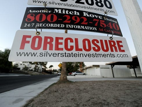A foreclosure sign is seen in front of a bank-owned home for sale in Las Vegas.