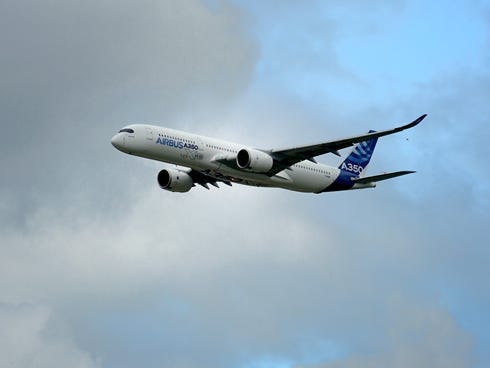 The new Airbus A 350 flies over Le Bourget airport near Paris on June 21, 2013 during the 50th International Paris Air show.