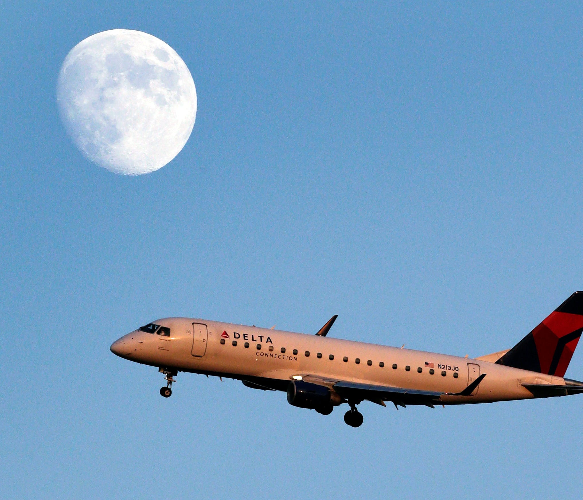 A Delta Connection Embraer E175 jet approaches LaGuardia airport, in New York on Aug. 28, 2012.
