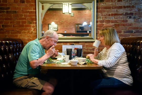 Duane Chadwell, left, and his wife Connie enjoy olive burgers at Weston's Kewpee Burger on Tuesday, July 16, 2019, in Lansing.