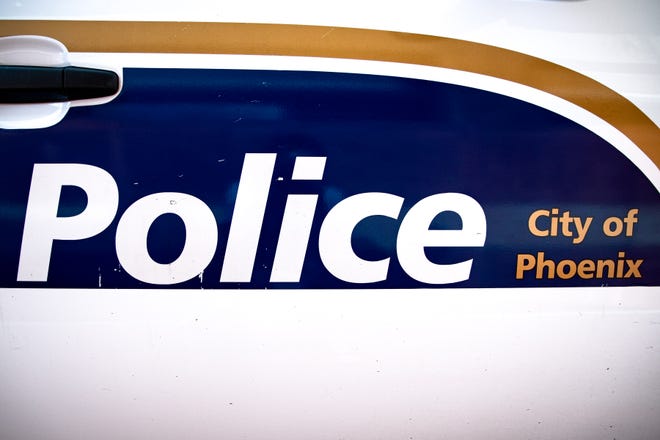 The side of a Phoenix Police vehicle is seen.
