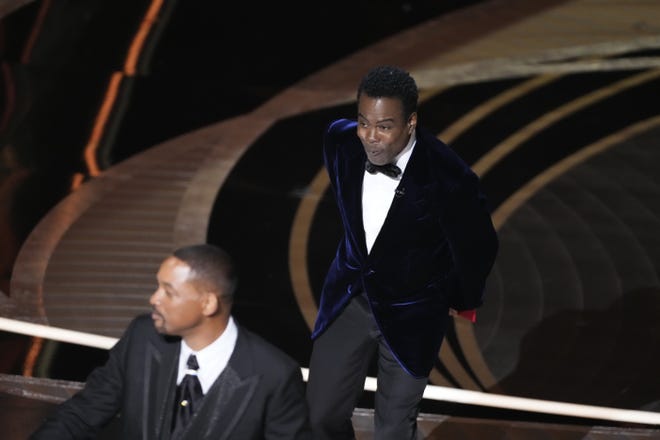 Will Smith walking off the Oscars stage after slapping presenter Chris Rock on March 27, 2022.