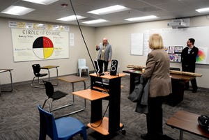 Andrew Glass, a clinical supervisor at Kitsap Mental Health Services, left, explains four values that students were taught in the Madrona Day Treatment program during a tour to the program's second classroom in Bremerton on April 13, 2022.