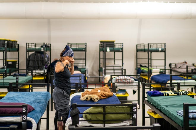 Sheila Morton, of Texas, spends time inside the Respiro structure at Central Arizona Shelter Services on Saturday, June 4, 2022, in Phoenix. The structure offers unhoused residents an enclosed air-conditioned area with a hundred beds.