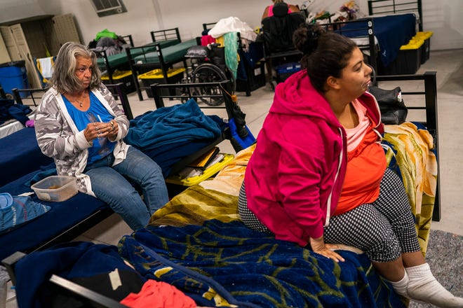 Nancy Gardner (left) and Diana Carreon (right) rest inside the Respiro structure at Central Arizona Shelter Services on Saturday, June 4, 2022, in Phoenix. Gardner has lived inside the air-conditioned structure for three weeks. She become unhoused when she was evicted by her landlord because she was not able to pay rent after recovering from stage four colon cancer.