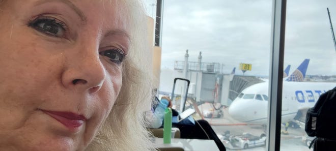 Alisal High School teacher Patricia Matulas Mason is waiting to board her flight to travel from San Francisco to Poland.