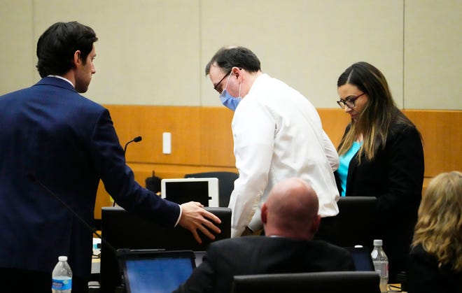 Accused murderer Bryan Patrick Miller (center), the so-called "Canal Killer" takes his seat in Maricopa County Superior Court in Phoenix on Oct. 3, 2022.