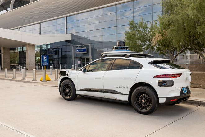 A Waymo vehicle is shown at the Sky Harbor International Airport drop off location.