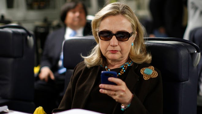 In this Oct. 18, 2011, file photo, then-Secretary of State Hillary Rodham Clinton checks her Blackberry from a desk inside a C-17 military plane upon her departure from Malta, in the Mediterranean Sea, bound for Tripoli, Libya.Clinton is telling voters not to trust Donald Trump, but a new government report about her usage of a private server as secretary of state is complicating that message. The sharp rebuke from the State Departments Inspector General, which found Clinton did not seek legal approval for her homebrew email server, guarantees that the issue will remain alive and well for the likely Democratic presidential nominee. (AP Photo/Kevin Lamarque, Pool, File)