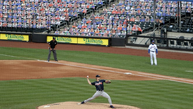 Atlanta Braves starting pitcher Mike Soroka, center, throws during the third inning of the baseball game against the New York Mets at Citi Field, Friday, July 24, 2020, in New York.