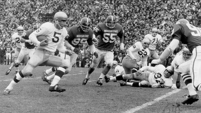 In a photo provided by Michigan State University, Notre Dame's Terry Hanratty carries the ball against Michigan State, Nov. 19, 1966 in East Lansing.