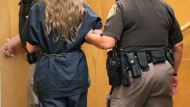 One of the two Wisconsin girls accused of stabbing a classmate is led out of a courtroom July 2. A judge on Tuesday halted his previous order for the girl to undergo an insanity exam.